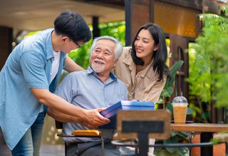 Younger couple giving gift to older relative