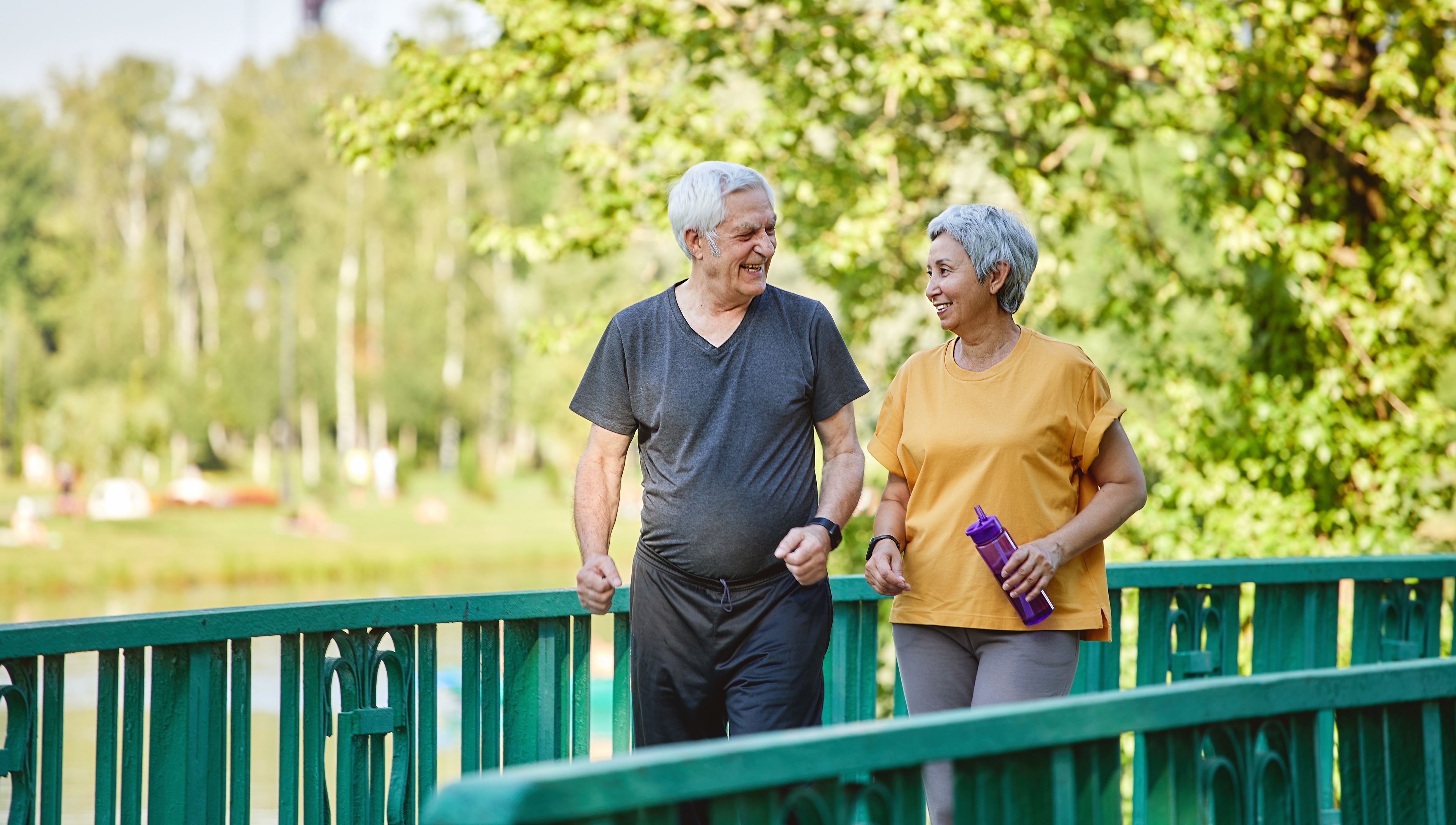Older couple exercising by walking outside