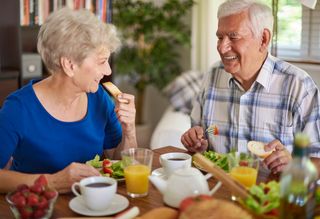 Older couple eating healthy food at home