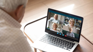 An older man on a video group counselling call with four peers
