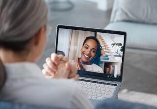 Older woman talking online with psychologist online