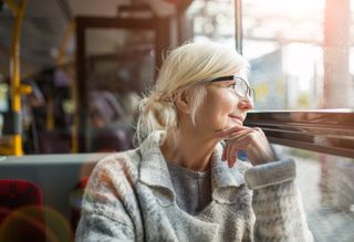 Older person looking out bus window