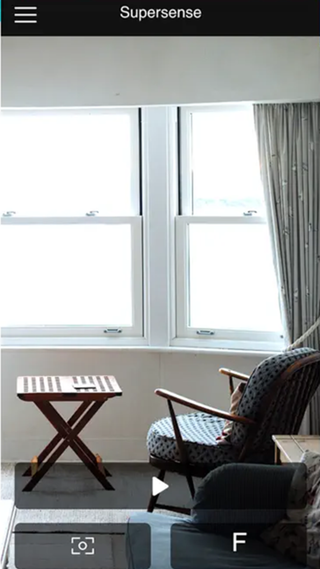 A screenshot of the Supersense app scanning a living room with an armchair and side table.