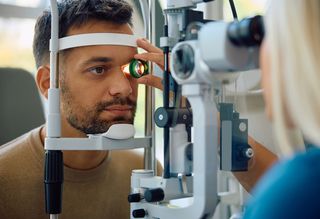 Younger man having his eyes tested by a medical professional