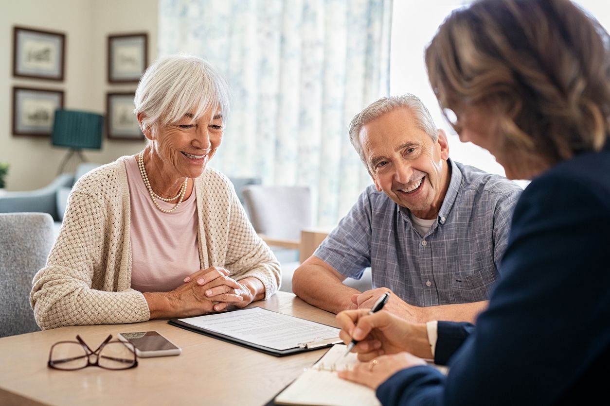 Older couple seated at a table with financial consultant