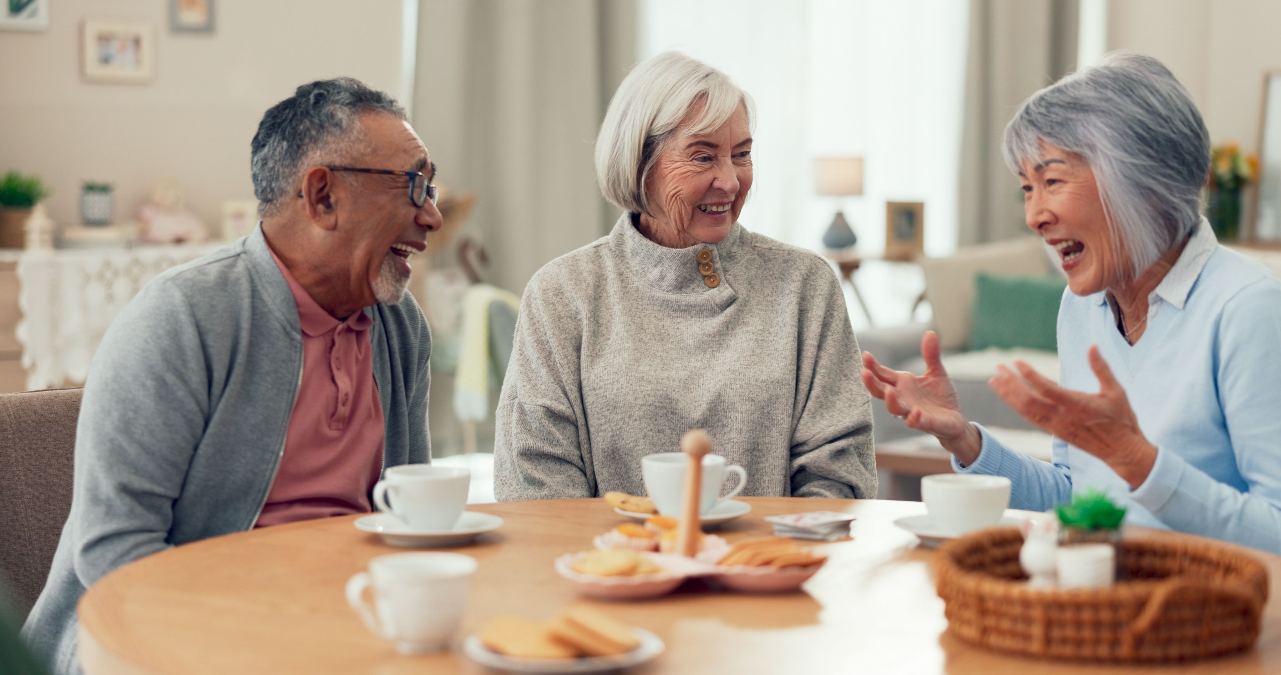 Three older people having morning tea together at home