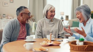 Three older people having morning tea together at home