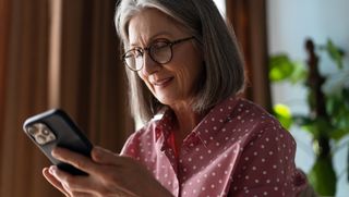 Older woman using a smartphone at home