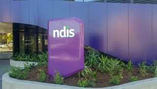 Purple NDIS sign outside building