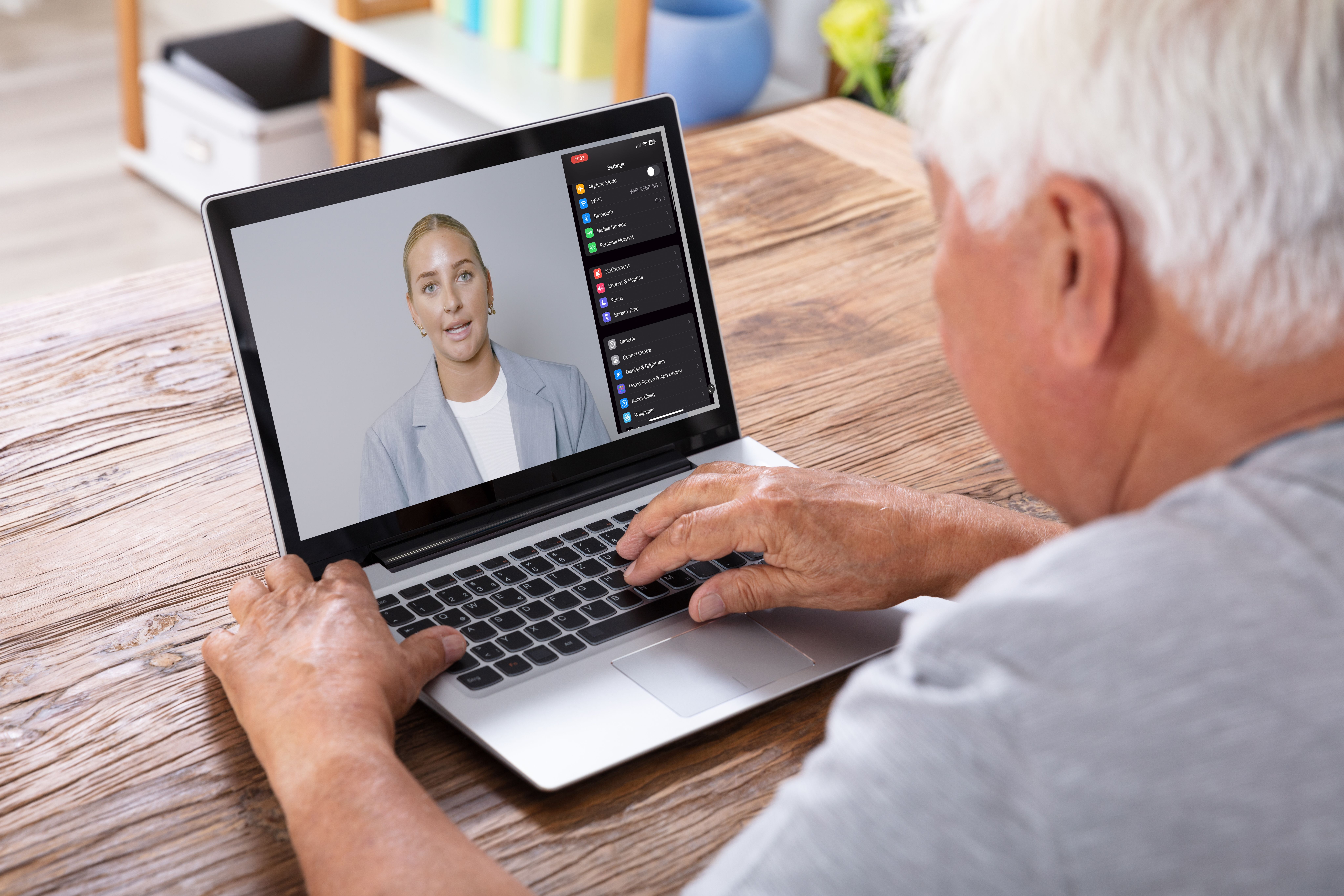 Person watching virtual training session on laptop