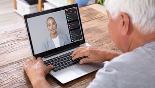 Person watching virtual training session on laptop