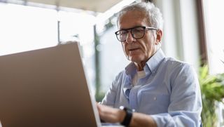 A man using a laptop at home.