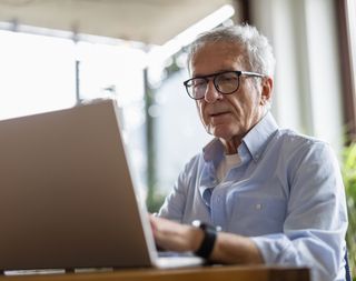 Older man working on a laptop