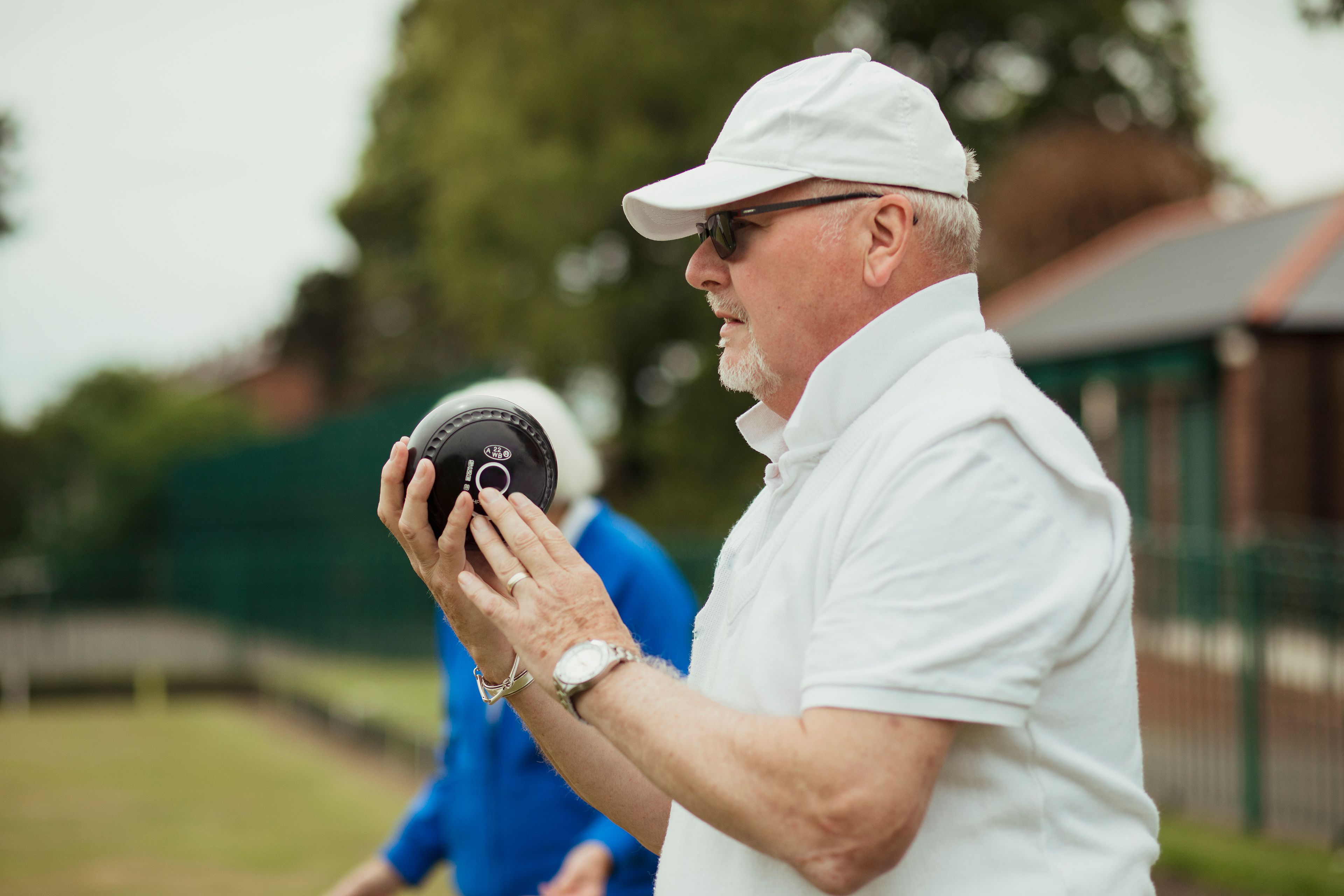 Older person playing lawn bowls 