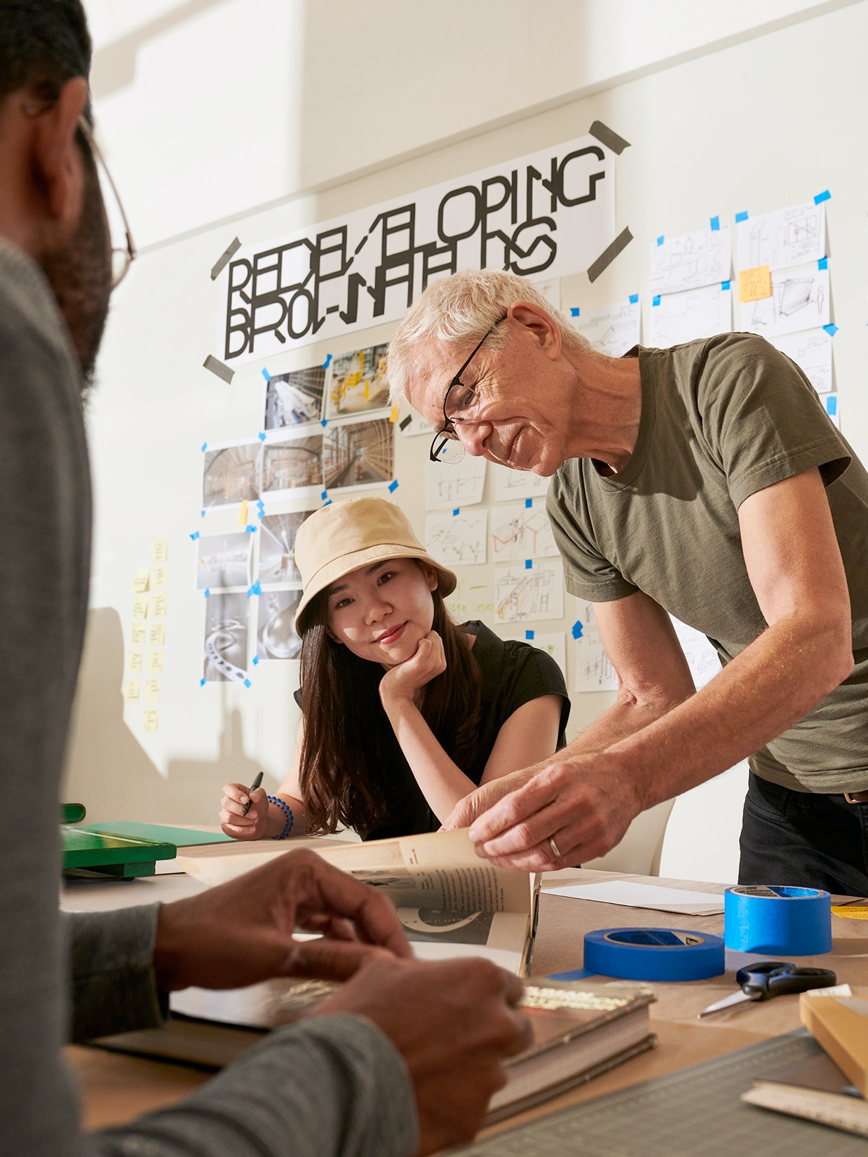 A man and woman doing crafts at a table.