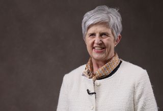 A headshot of Suzi smiling at the camera