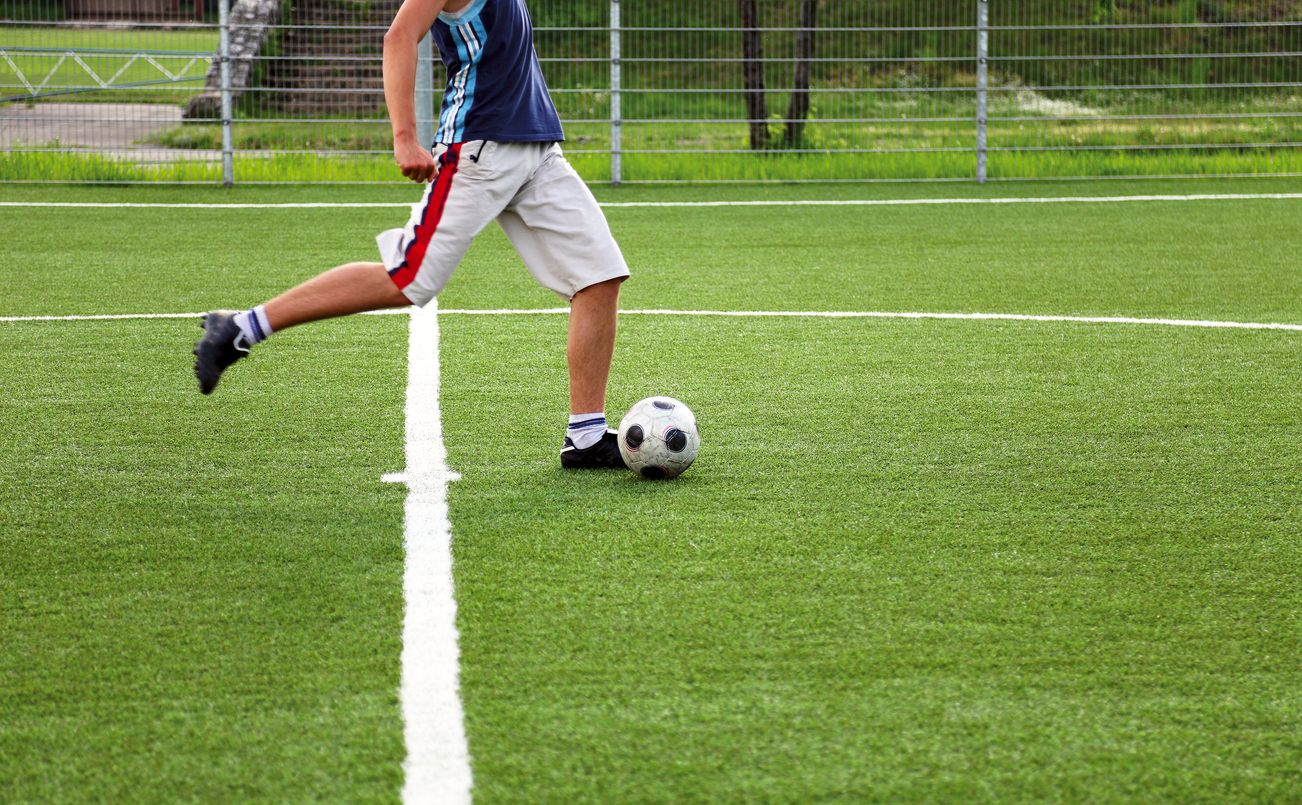Person kicking a soccer ball