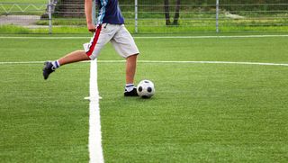 Person kicking a soccer ball