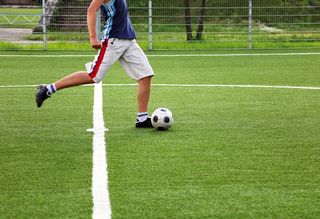 Person kicking a soccer ball