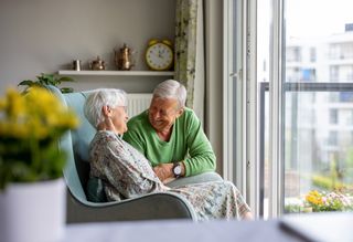 Happy older couple sitting at home