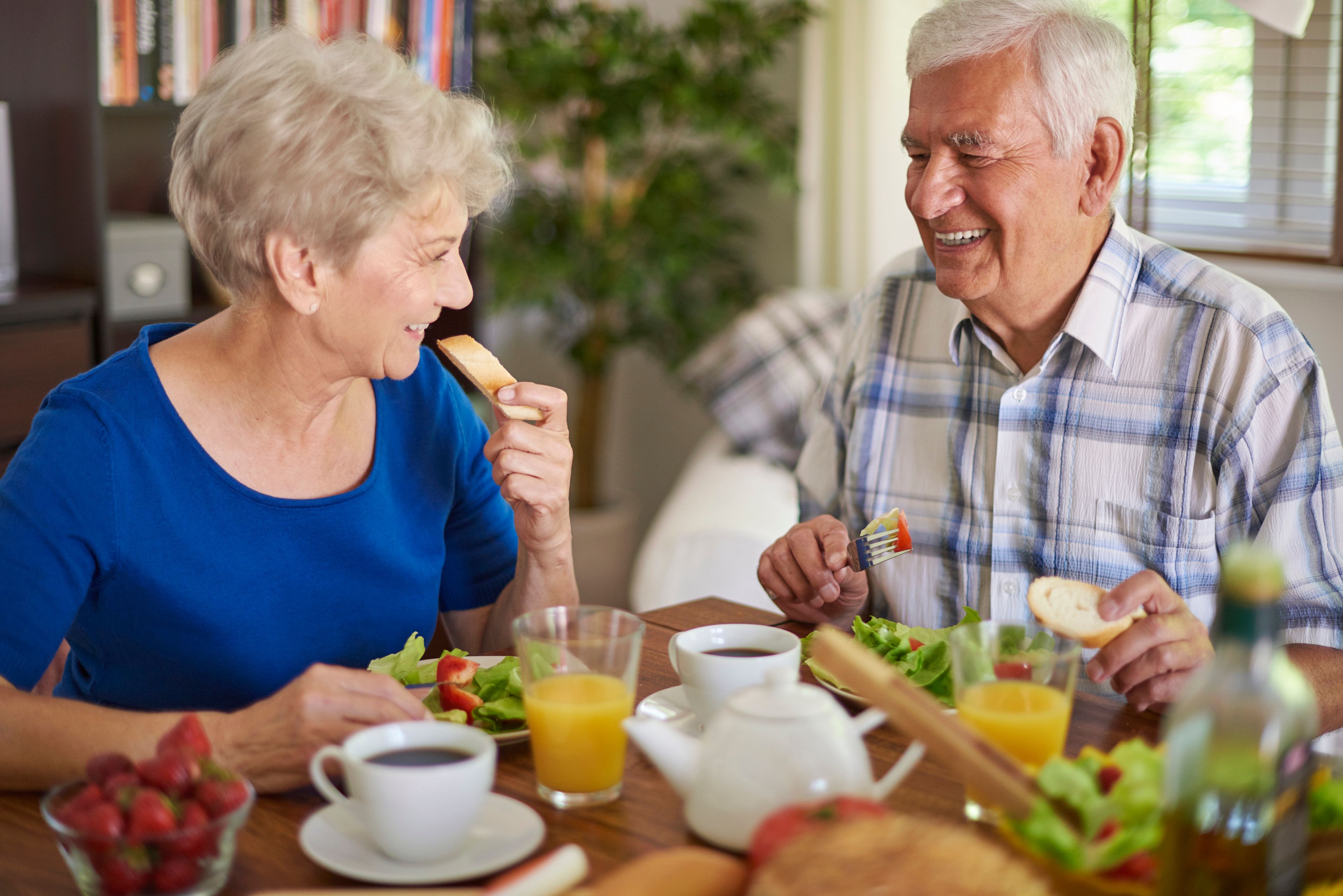 Older couple eating healthy food at home
