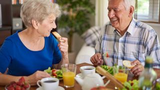 Older couple eating healthy food at home