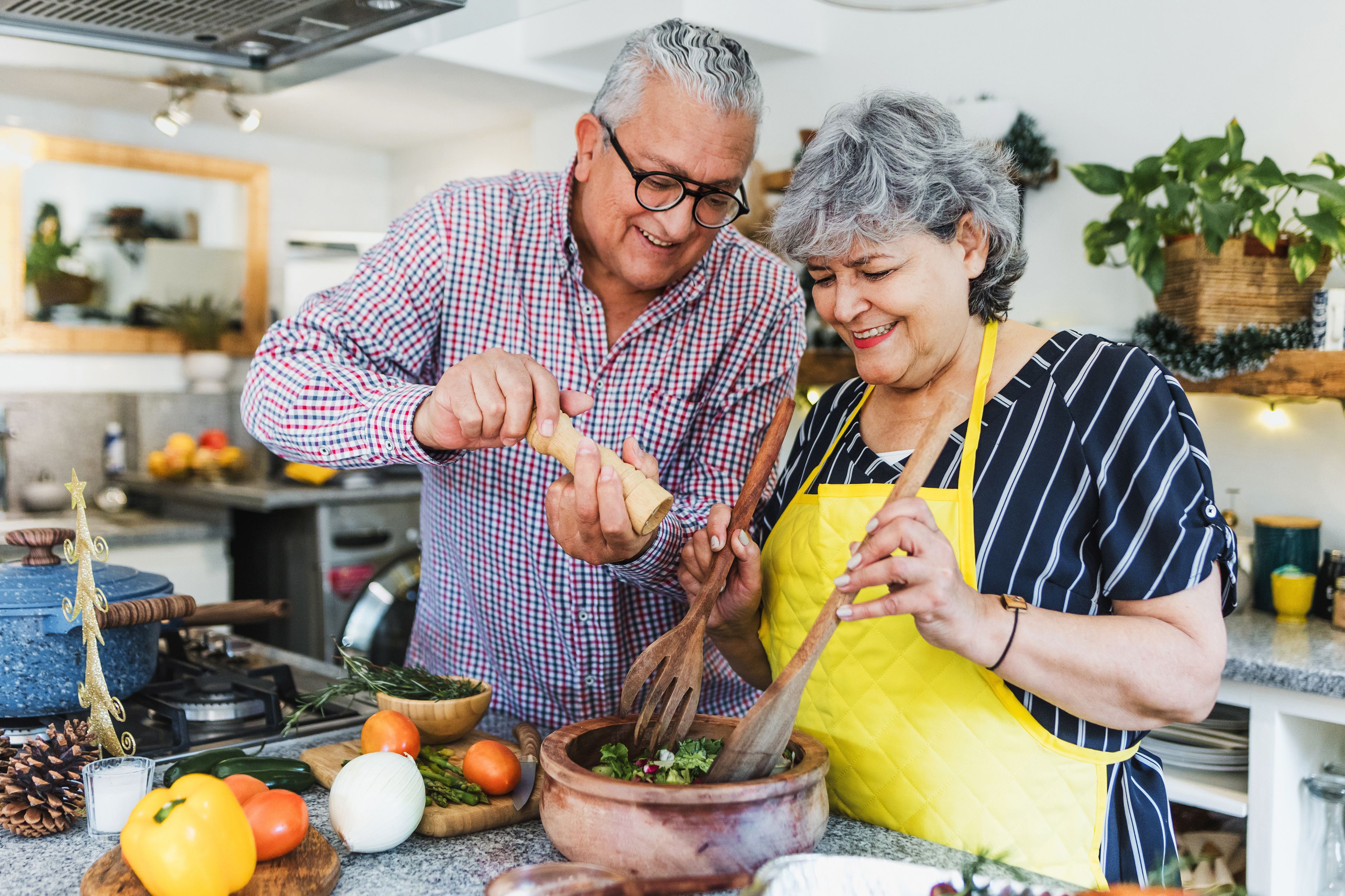 Older couple cooking together in kitchen