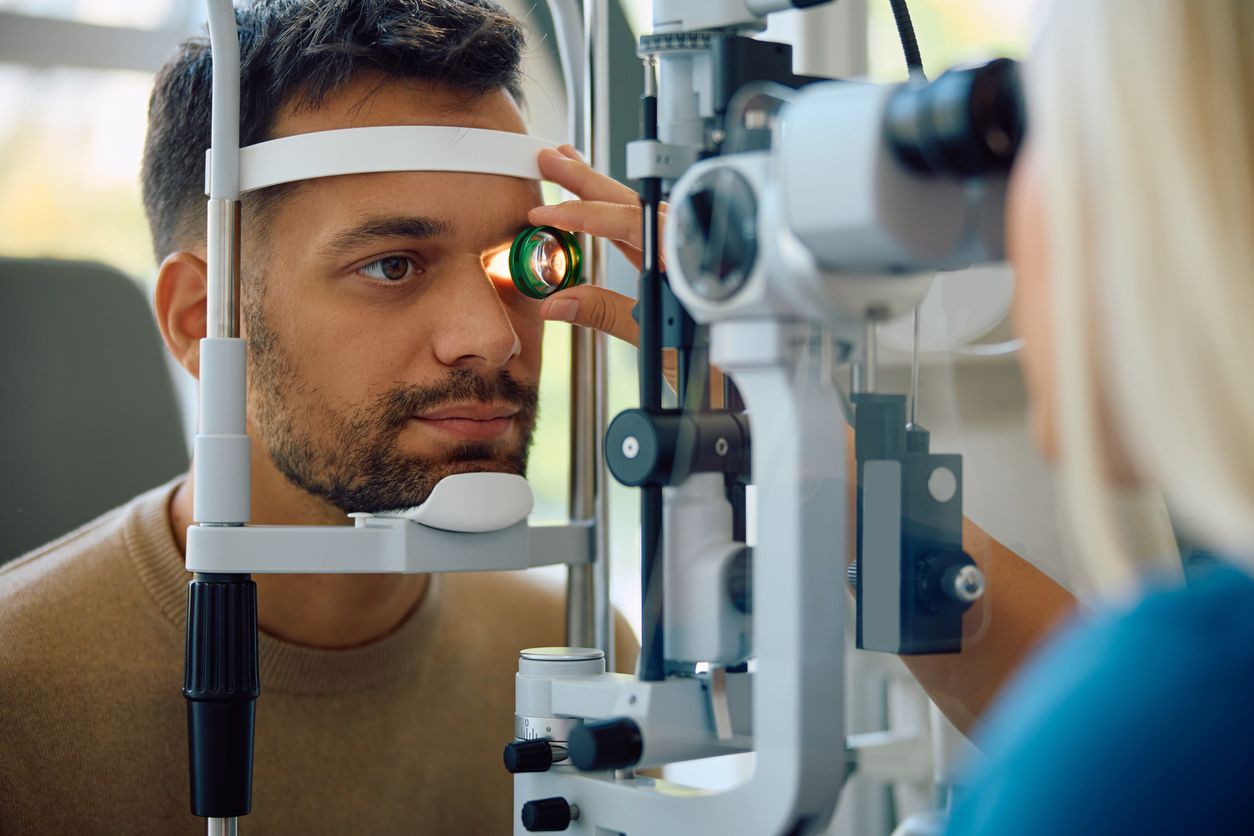 Younger man having his eyes tested by a medical professional