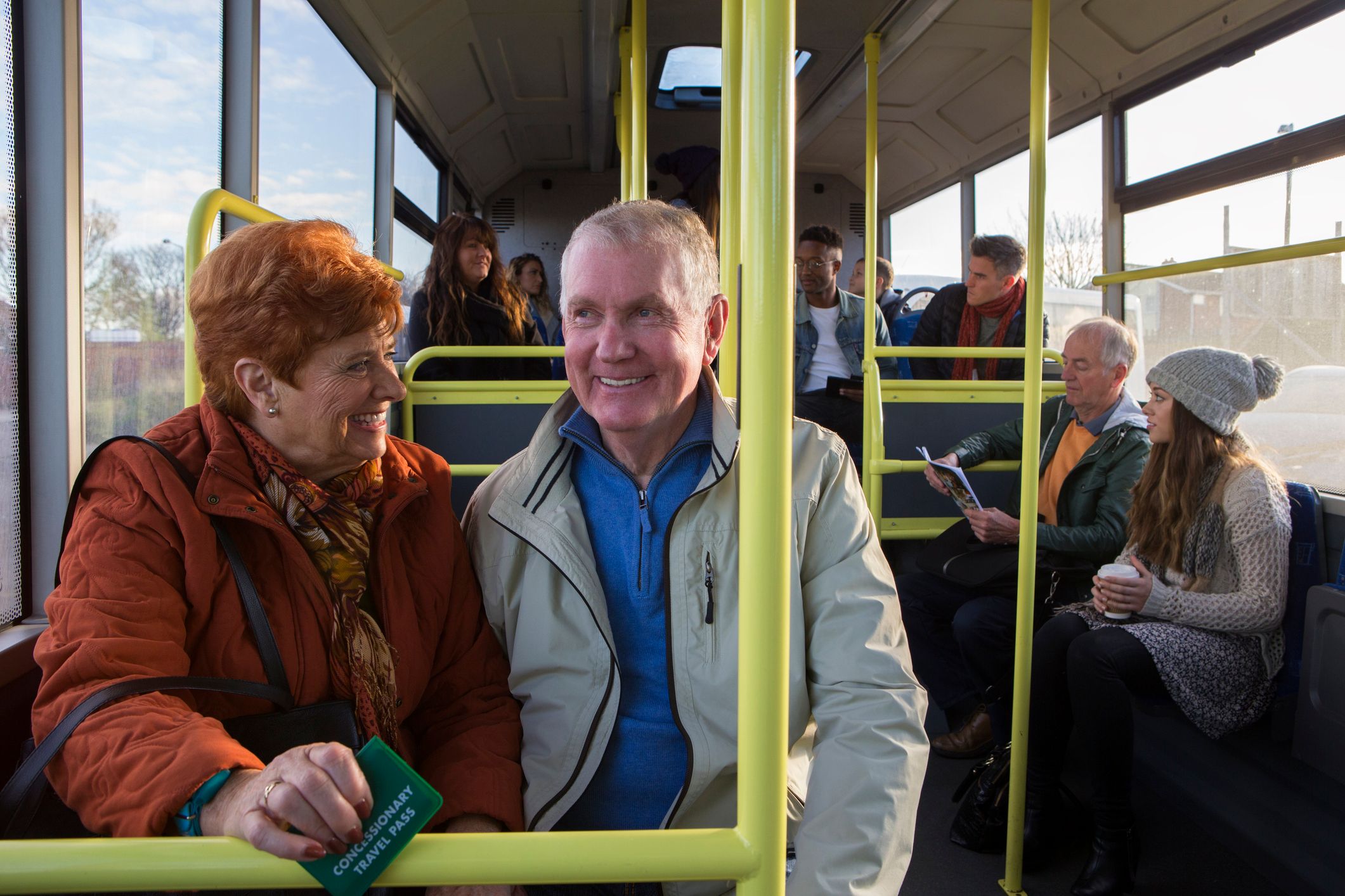 Happy older couple sitting together on a bus