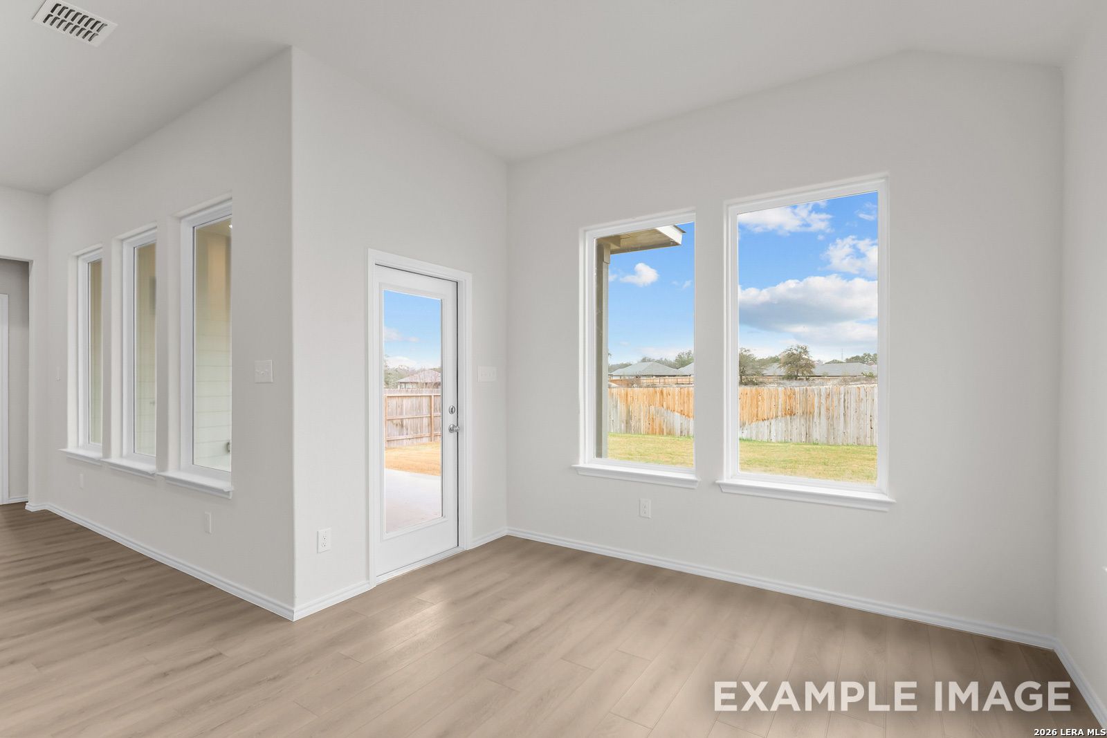 Bright dining area with large windows and backyard access in The Sequoia C floor plan by Davidson Homes, San Antonio.