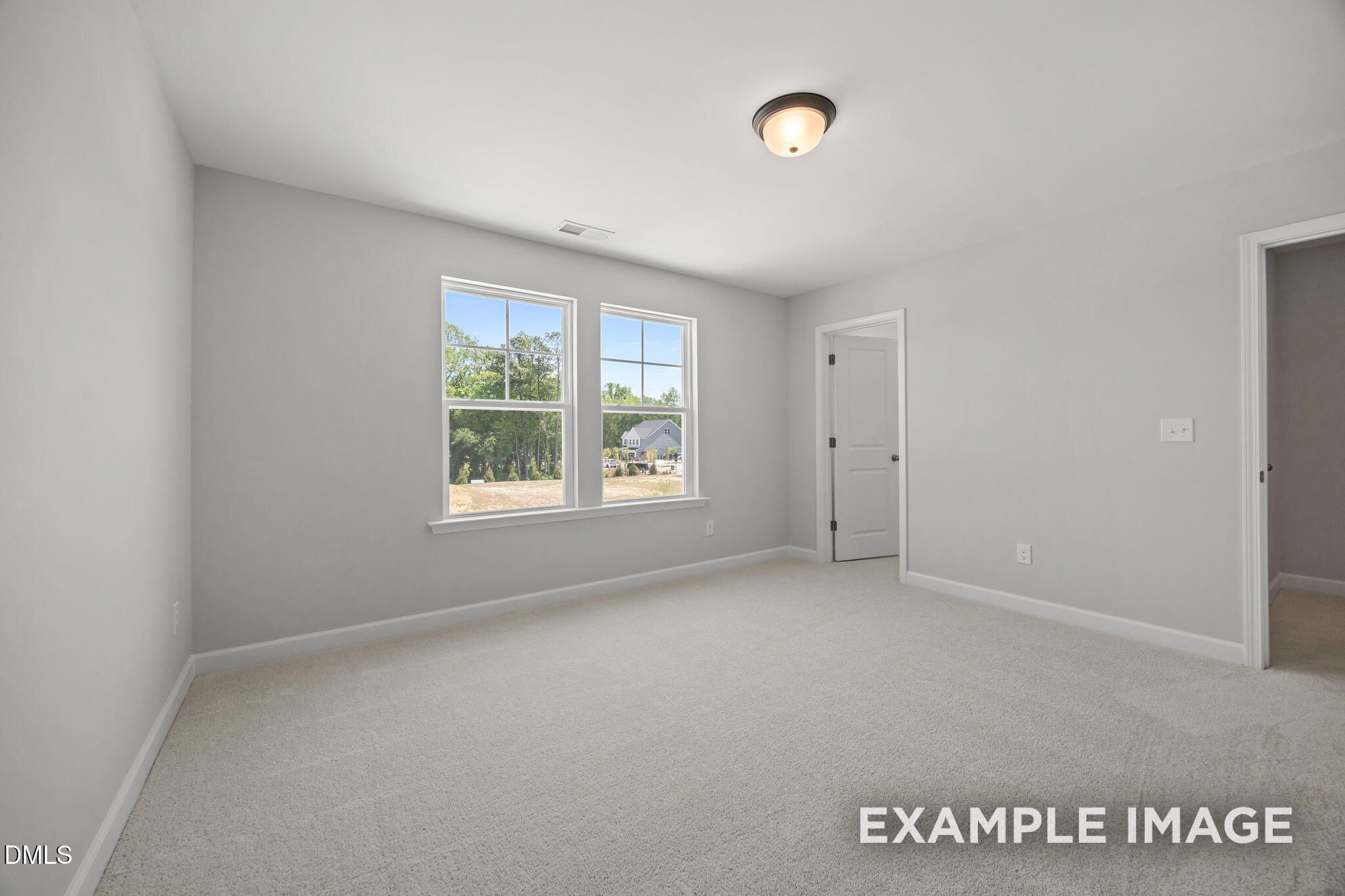 Bright upstairs bedroom with carpet, double windows, and neutral walls in Davidson Homes The Beech plan at Wendell Ridge, NC
