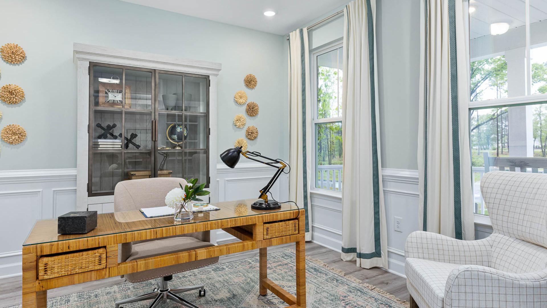 Cozy Davidson Homes office with wooden desk, swivel chair, glass cabinet, potted plant, and large windows in blue room