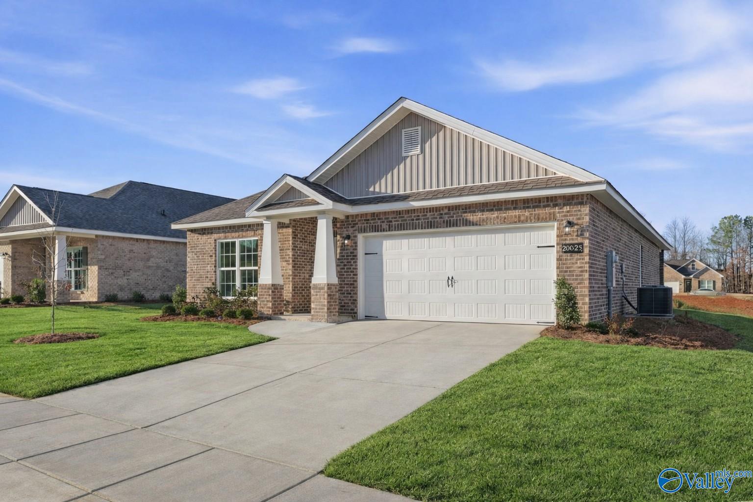 Modern 1-story 4-bedroom home with 2-car garage, brick facade, and lush lawn in Ricketts Farm, Athens, Alabama by Davidson Homes The Daphne C