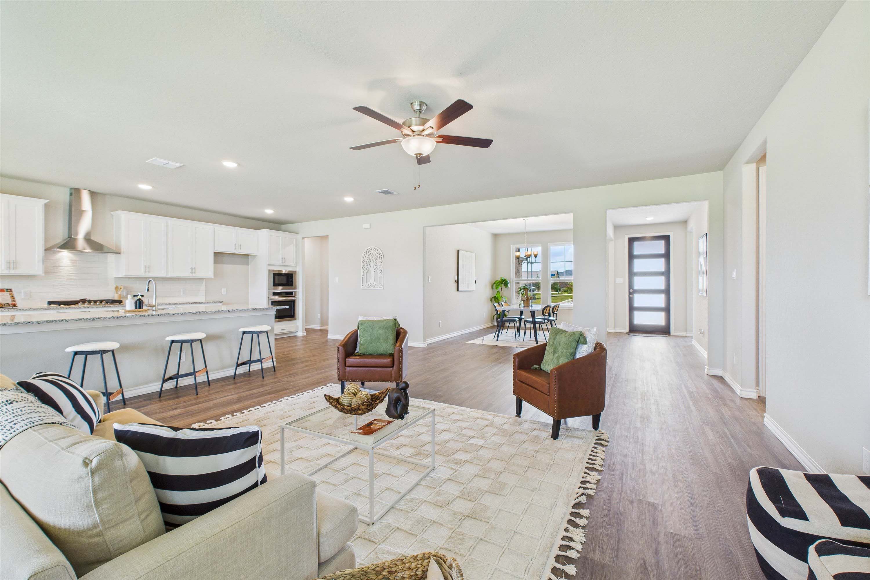 Open-concept living room and kitchen in The Foster by Davidson Homes featuring a spacious layout and modern interior design.