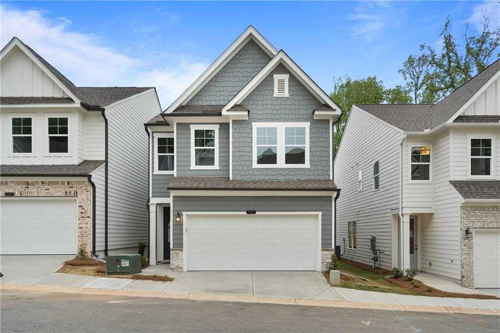 Modern gray two-story Cary B home with two-car garage and brick accents in The Village at Shallowford, Kennesaw, Georgia