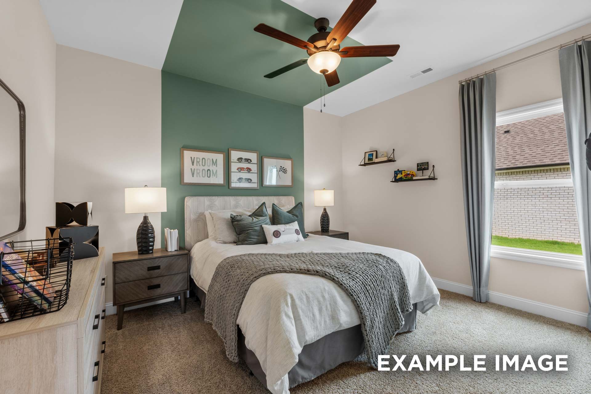 Serene master bedroom in The Laurel N with green accent wall, plush gray bed, wooden nightstands, ceiling fan, and window light