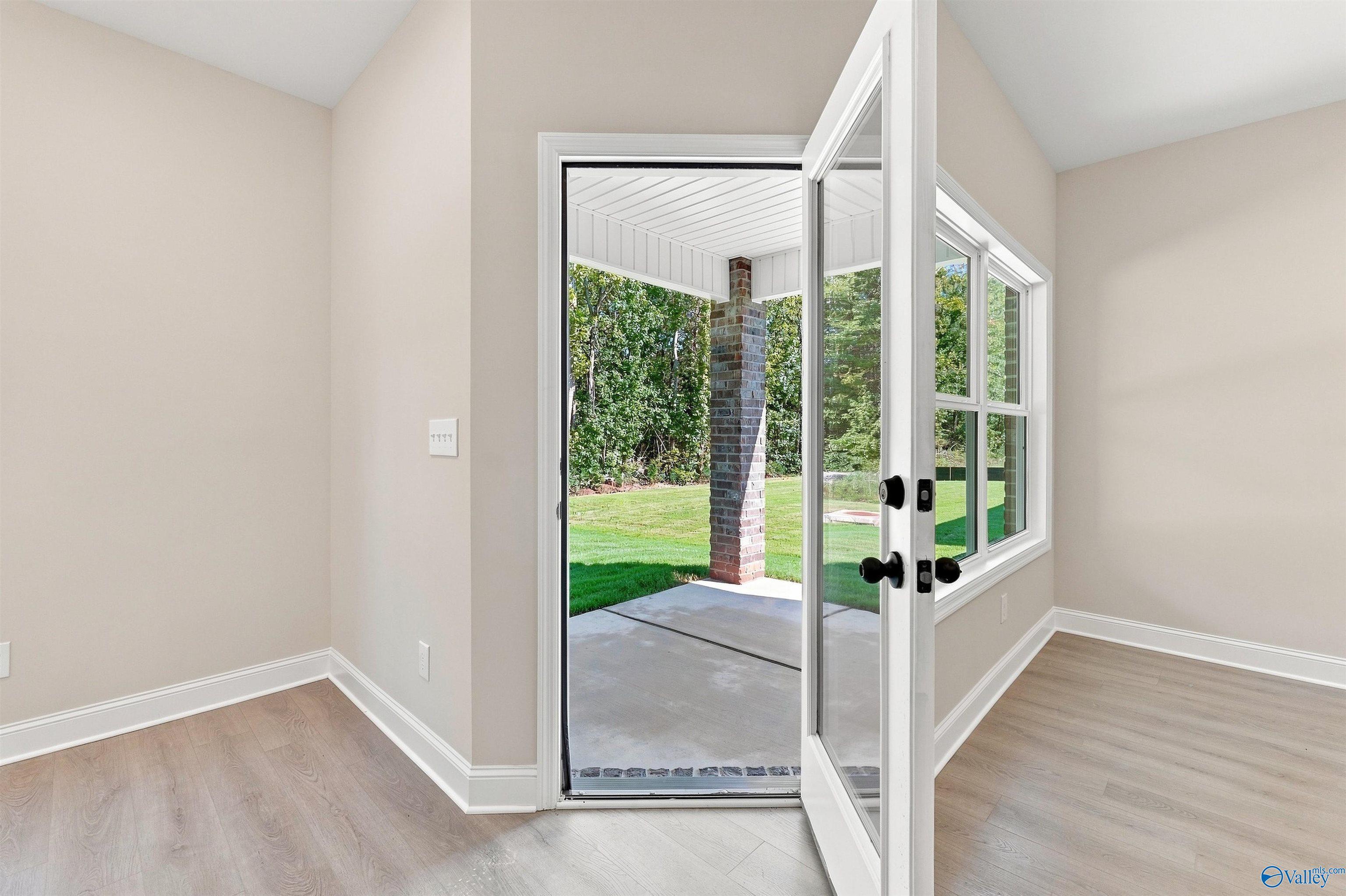Glass door opening to a covered back patio in The Daphne floor plan by Davidson Homes in Spragins Cove, Huntsville, AL.