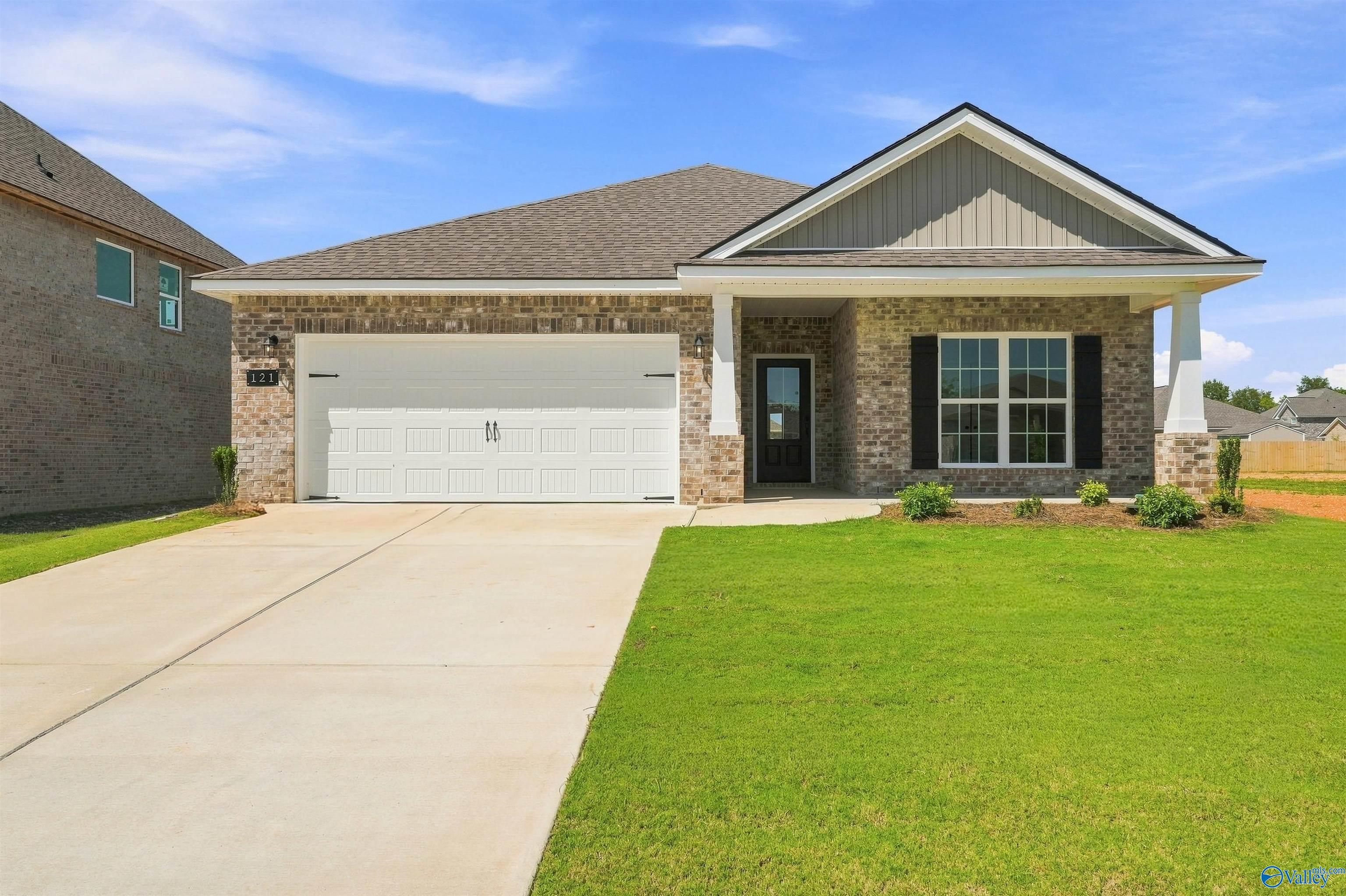 Single-story Everett B floor plan by Davidson Homes with brick exterior, 2-car garage, and lawn in Ivy Hills, Toney, AL.