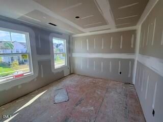 Unfinished bedroom with drywall and subflooring in The Hickory II B floor plan at Woodland Crossing in Zebulon, NC.