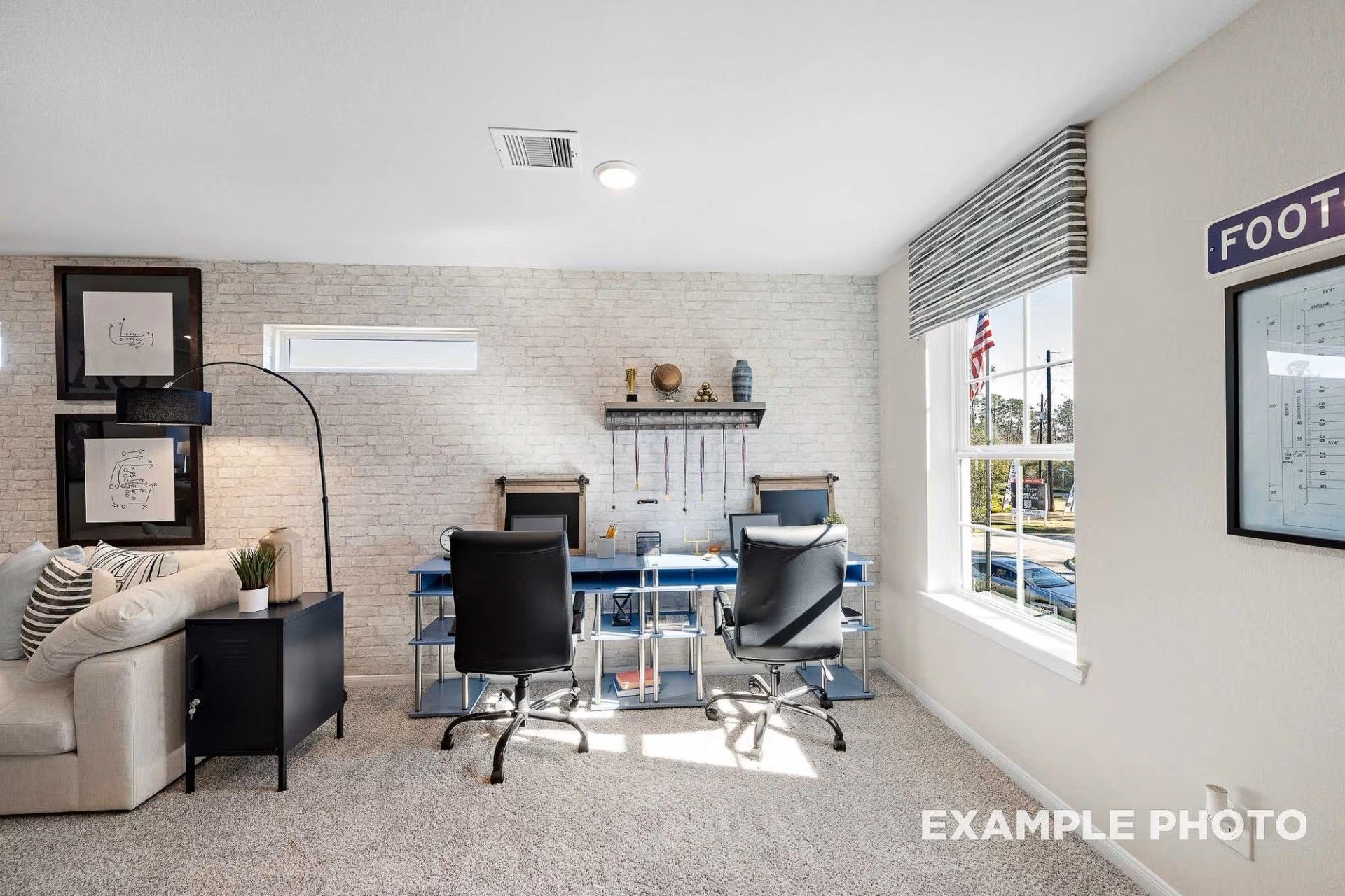 Home office with double desk and faux brick wall in The San Marcos E floor plan by Davidson Homes in Heartland, Texas.