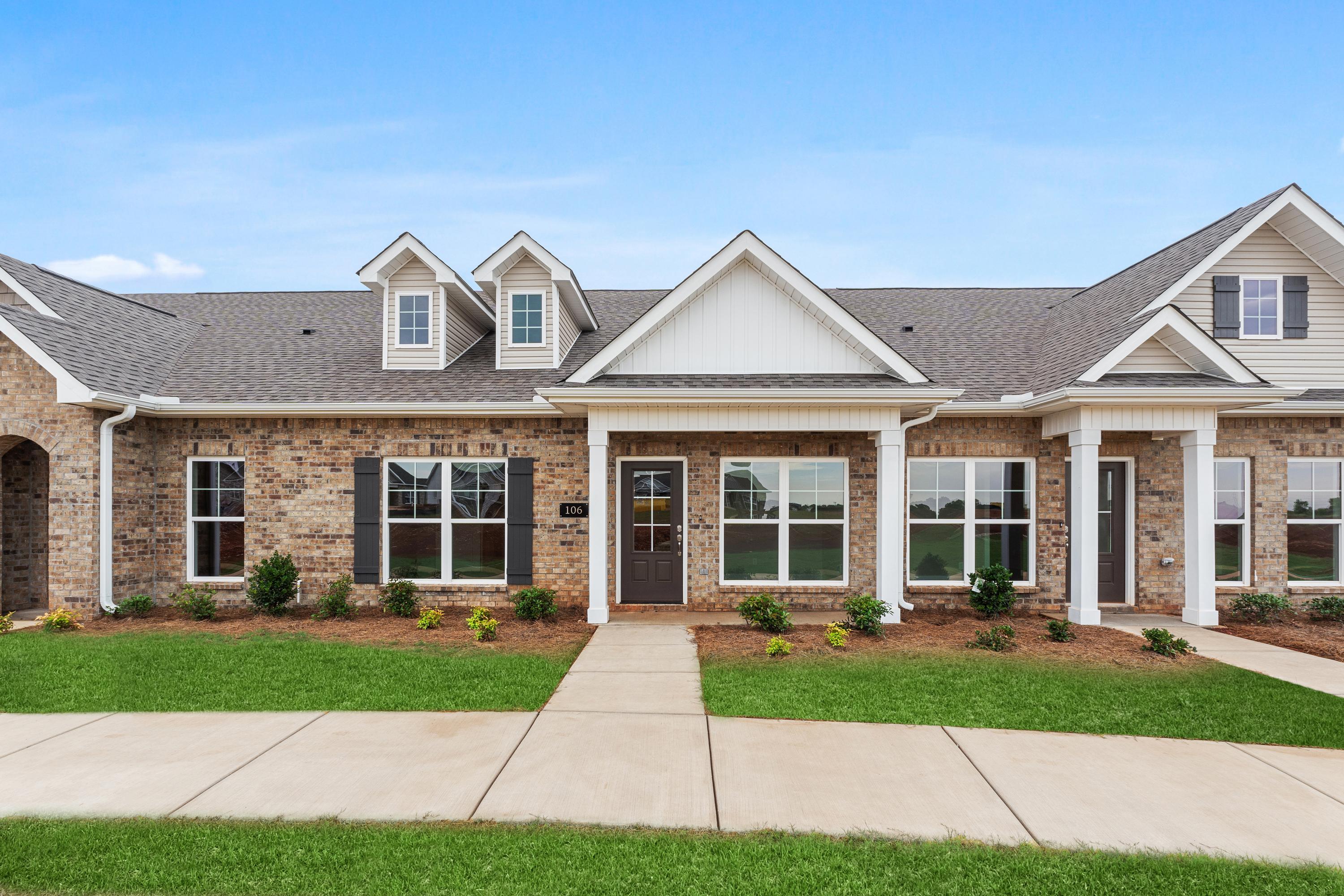 Charming 1-story Copeland C multi-family home elevation with brick and siding facade, covered porch, and attached 2-car garage in Madison, Alabama