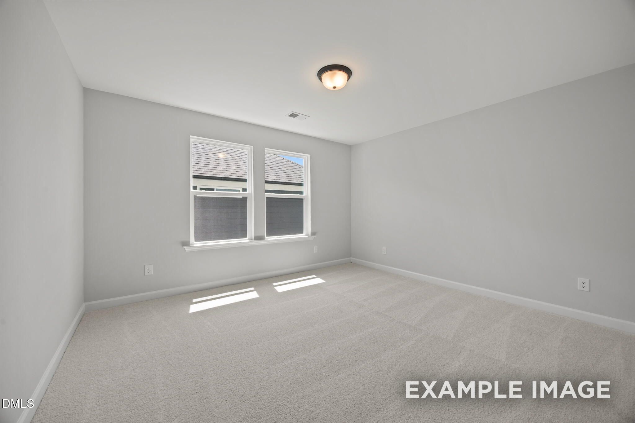 Bright, spacious bedroom with carpet, neutral walls, and double windows in Davidson Homes The Beech plan at Wendell Ridge, NC