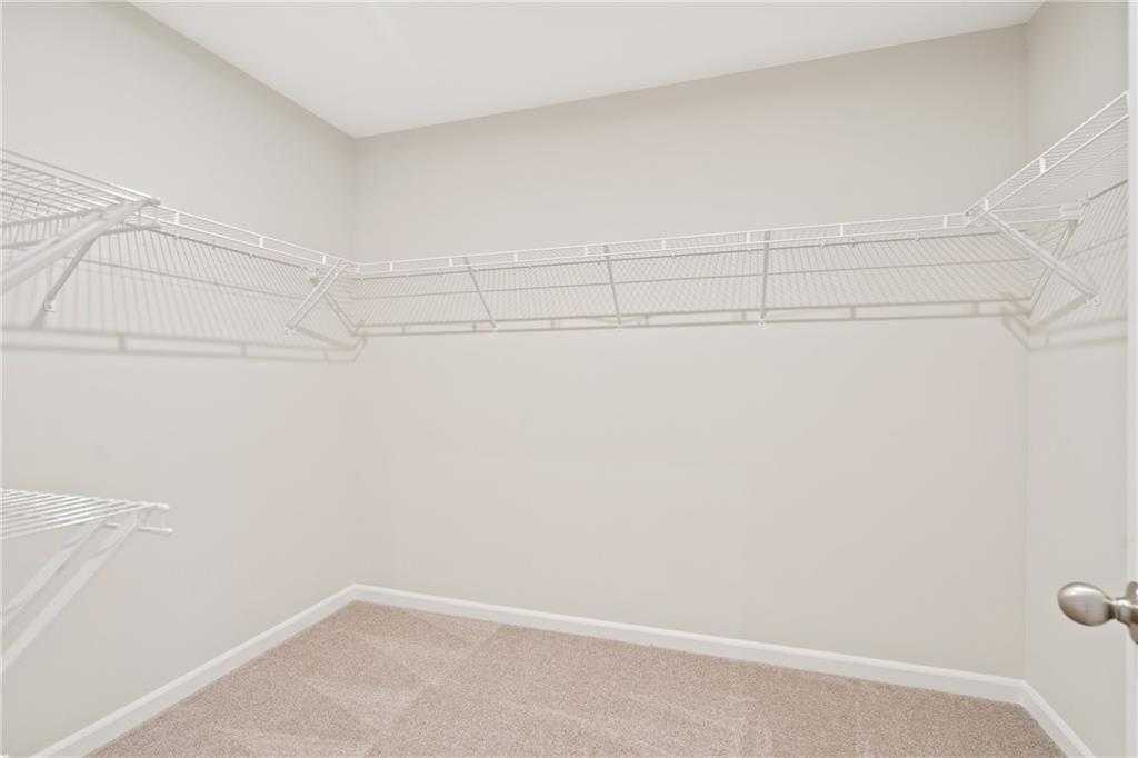 Spacious walk-in closet with white wire shelving in master suite of Davidson Homes The Cary B, Kennesaw, Georgia