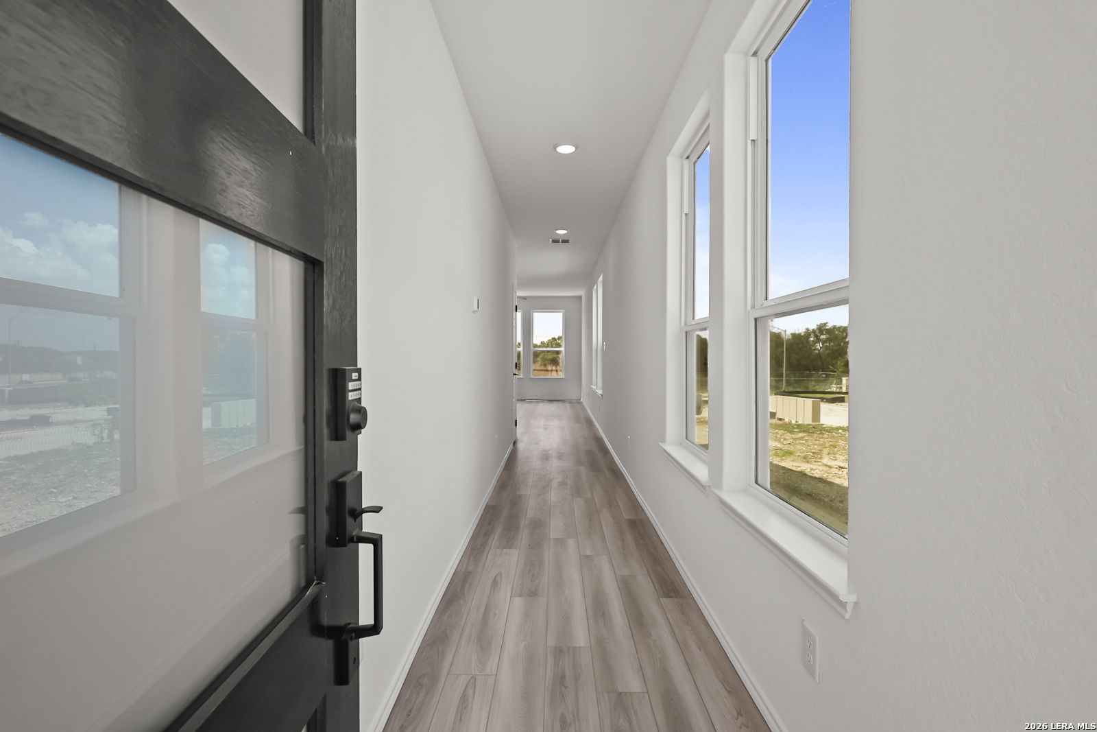Bright entryway with wood-look flooring in The Florence B floor plan at Meadows at Oak Creek, San Antonio, Texas.