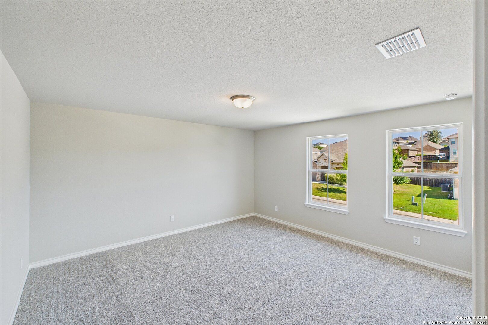 Bright secondary bedroom with large windows overlooking green lawn in Davidson Homes The Jennings H, Ladera, San Antonio