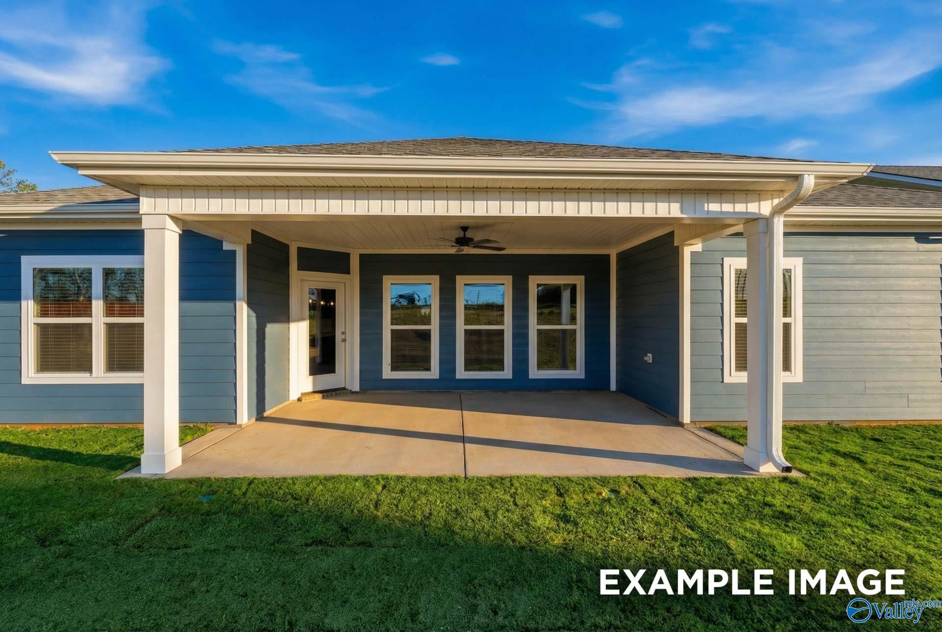 Covered back patio with columns, ceiling fan, and large windows on blue-sided Davidson Homes in Anderson Farm, Athens, Alabama