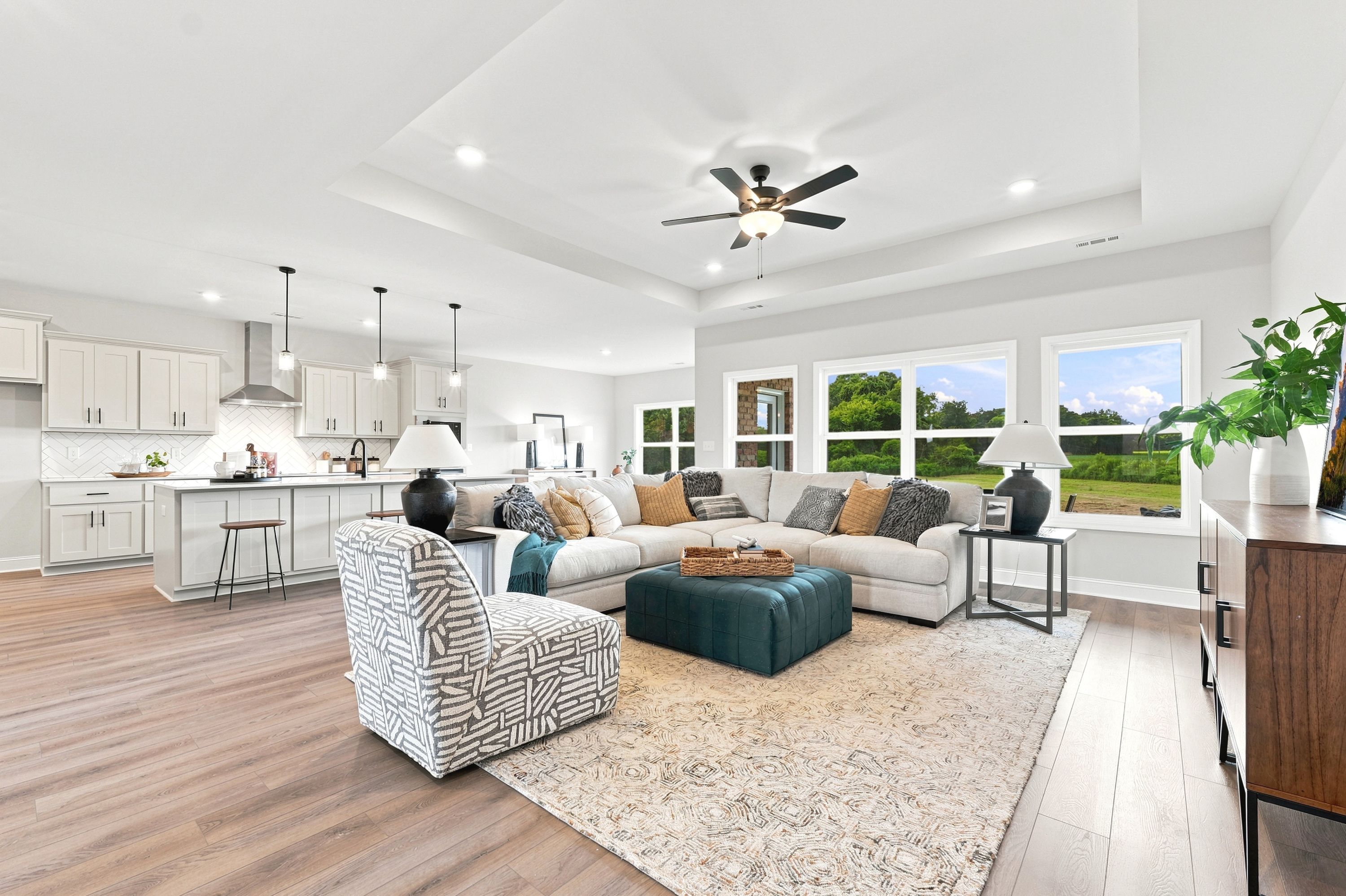Open-concept living room and kitchen at Riverton Preserve in Huntsville, AL by Davidson Homes with modern luxury finishes.