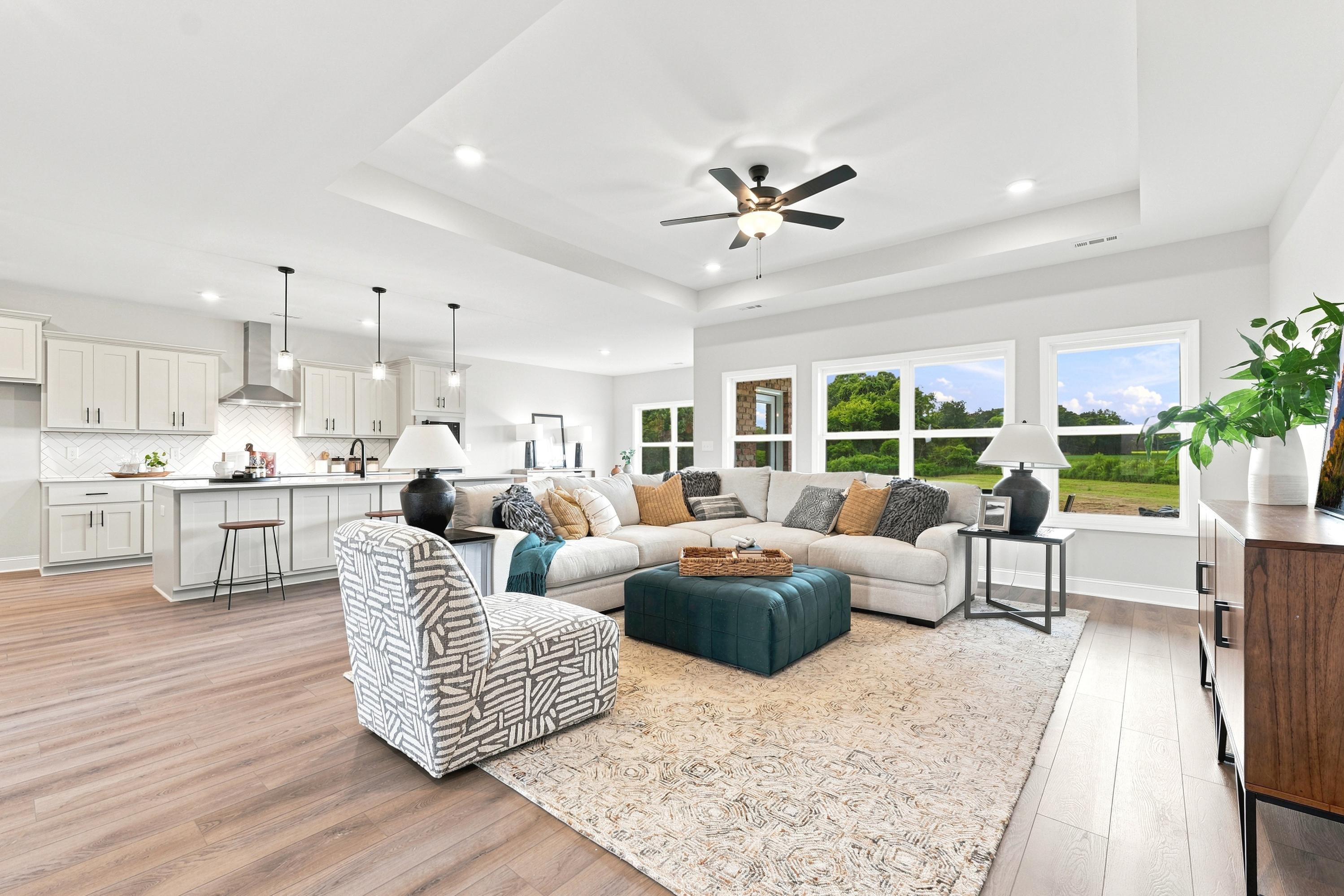 Open-concept living room and kitchen at Riverton Preserve in Huntsville, AL by Davidson Homes with modern luxury finishes.