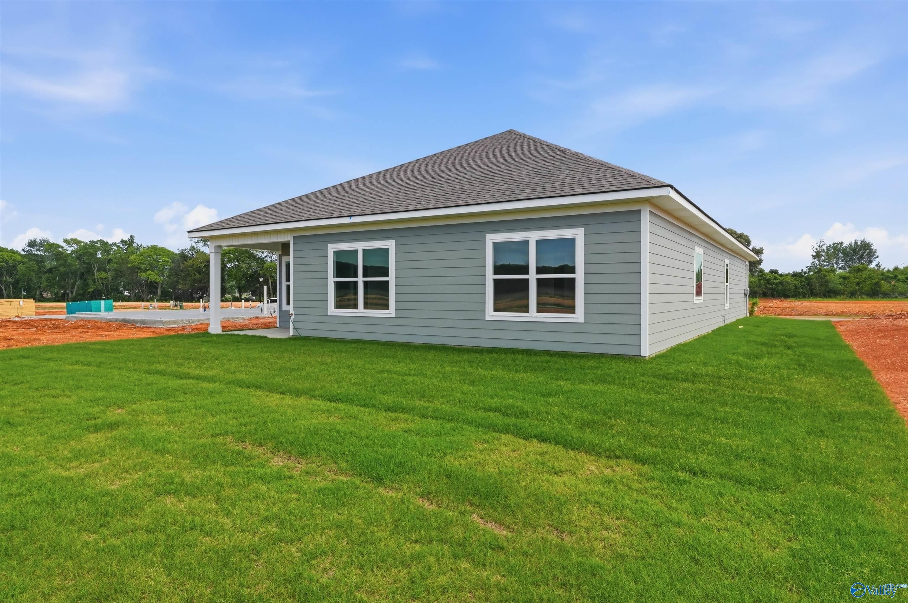 Exterior view of The Daphne F floor plan by Davidson Homes featuring a spacious backyard in Berry Cove, New Market, AL.
