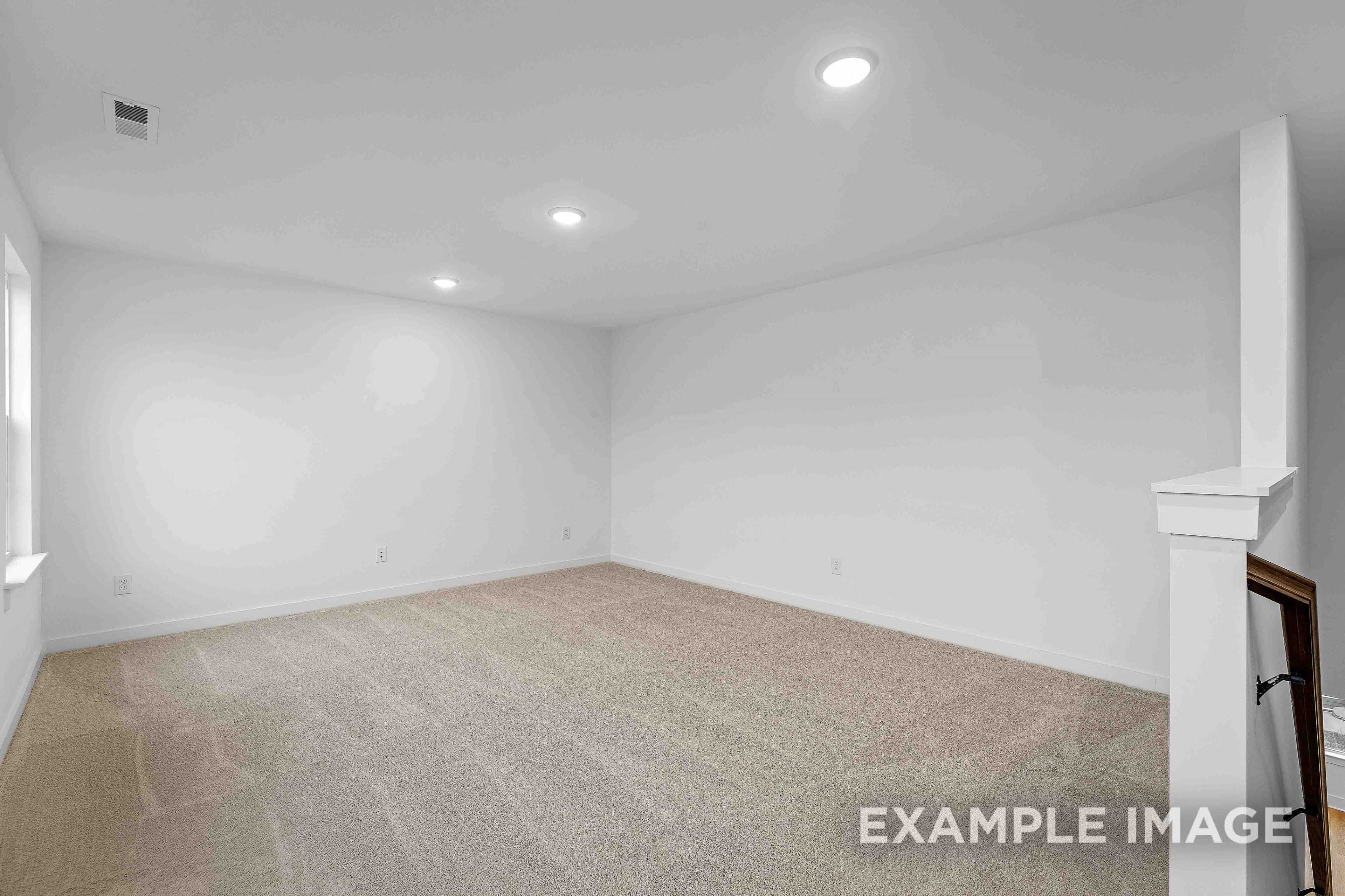 Spacious empty upstairs bedroom in The Charleston C with white walls, beige carpet flooring, recessed lights, and window sill